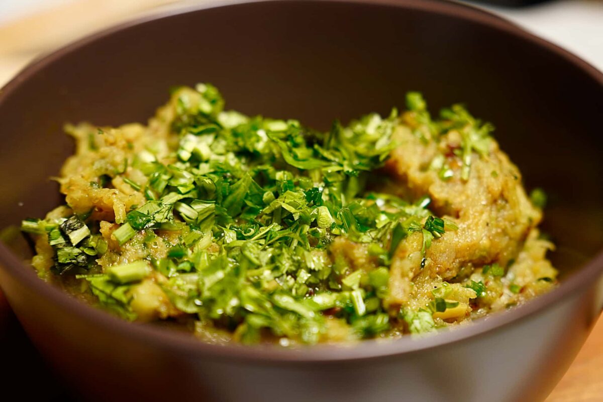 Baigan Bharta served with fresh coriander garnish in bowl revealing amazing texture