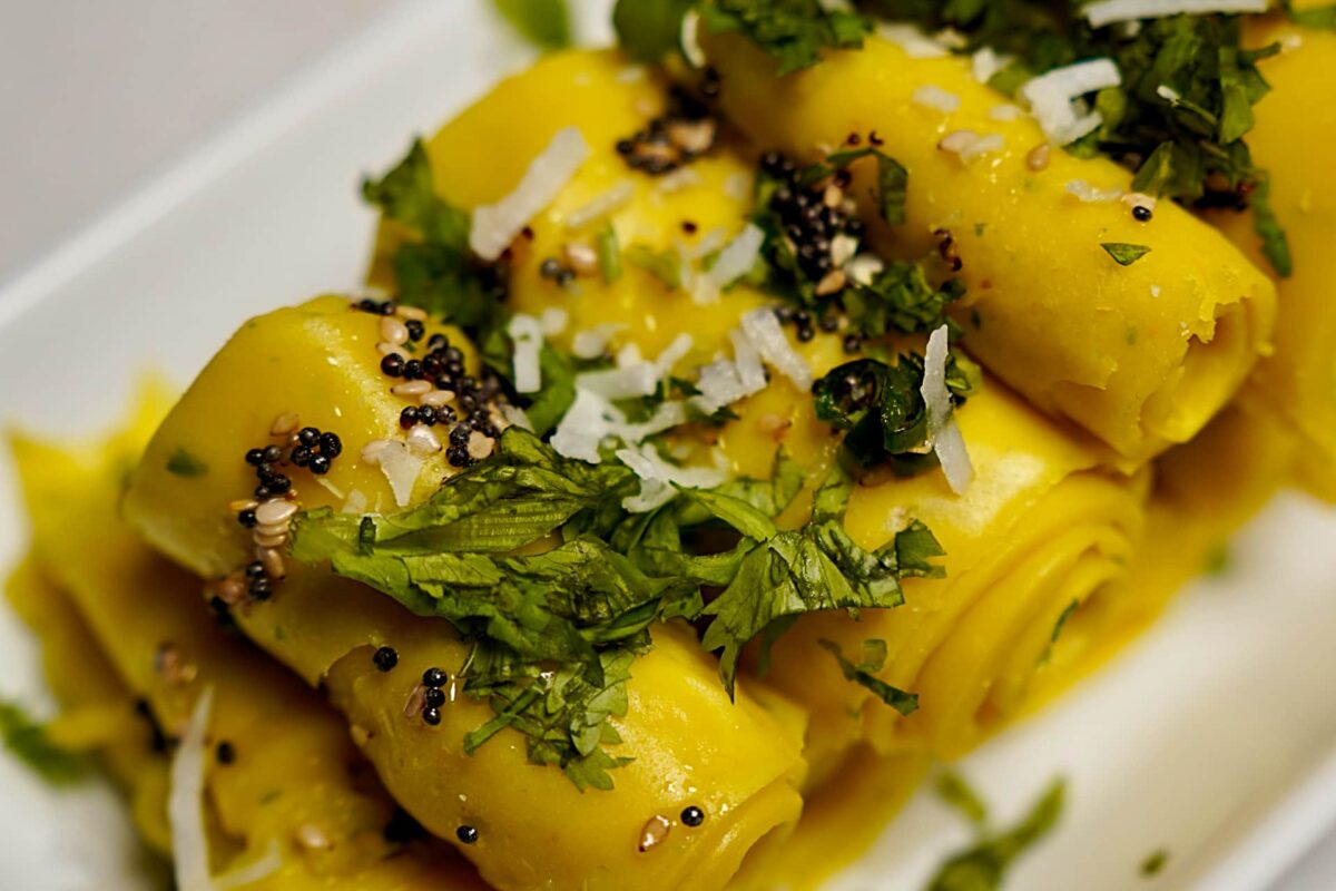 Khandvi garnished with shredded coconut, ready to be served as a delicious snack.