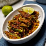 Bharela Bhinda: Crispy fried stuffed okra served on a plate.