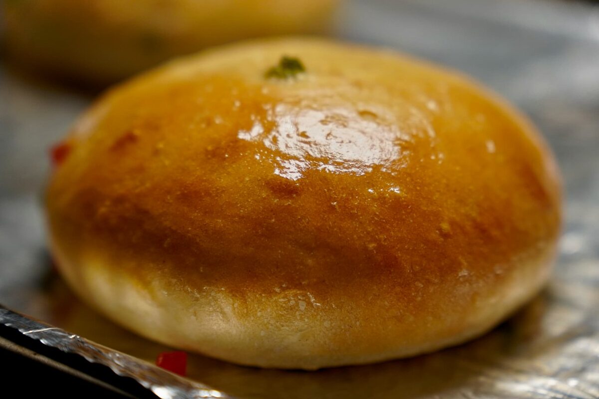 Golden brown Bun Maska buns cooling on a rack, perfect for serving with butter or malai.