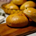 Close-up of soft, sweet Bun Maska studded with tutti frutti, ready to serve.