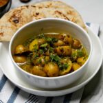 Aloo Methi Gravy served in a bowl, showcasing its rich color and texture.