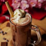 Cold Coco served in a glass, topped with a scoop of vanilla ice cream for a delicious treat.