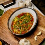 Overhead view of Pomfret Fish Curry, showcasing the rich colors and aromatic spices in the dish.