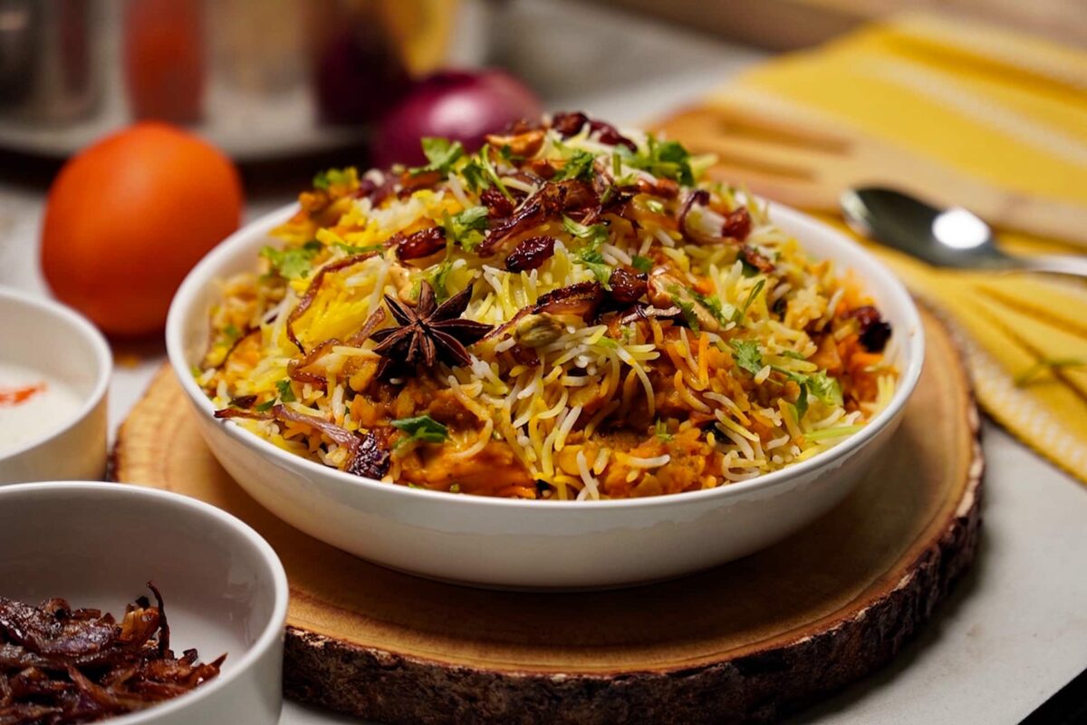 Dal Biryani garnished with fresh herbs, fried cashews, and saffron-infused rice