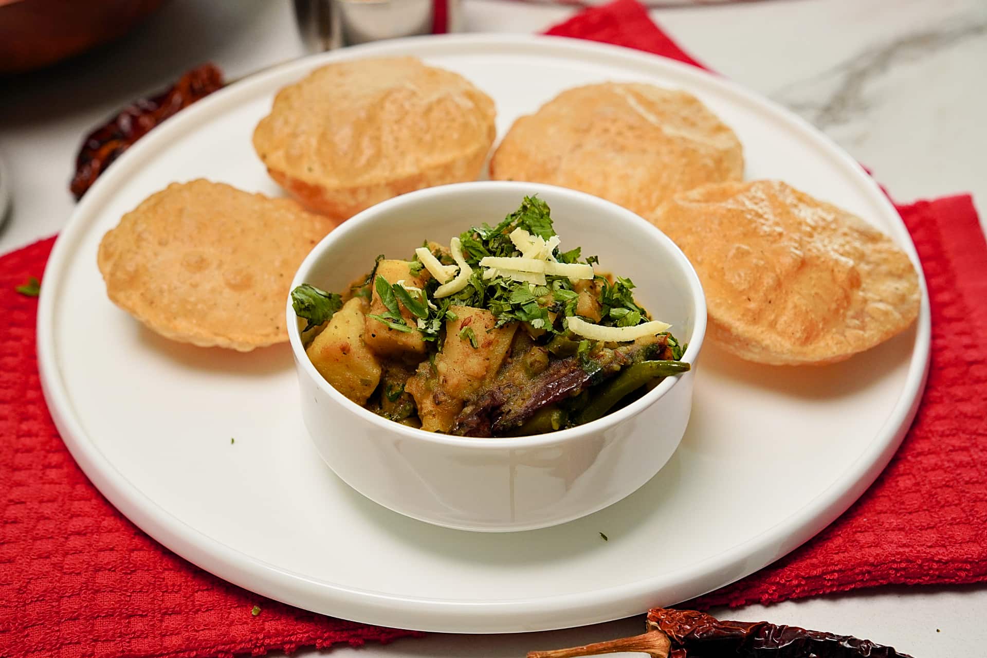 Close-up of perfectly fried, puffy puri and aloo subji