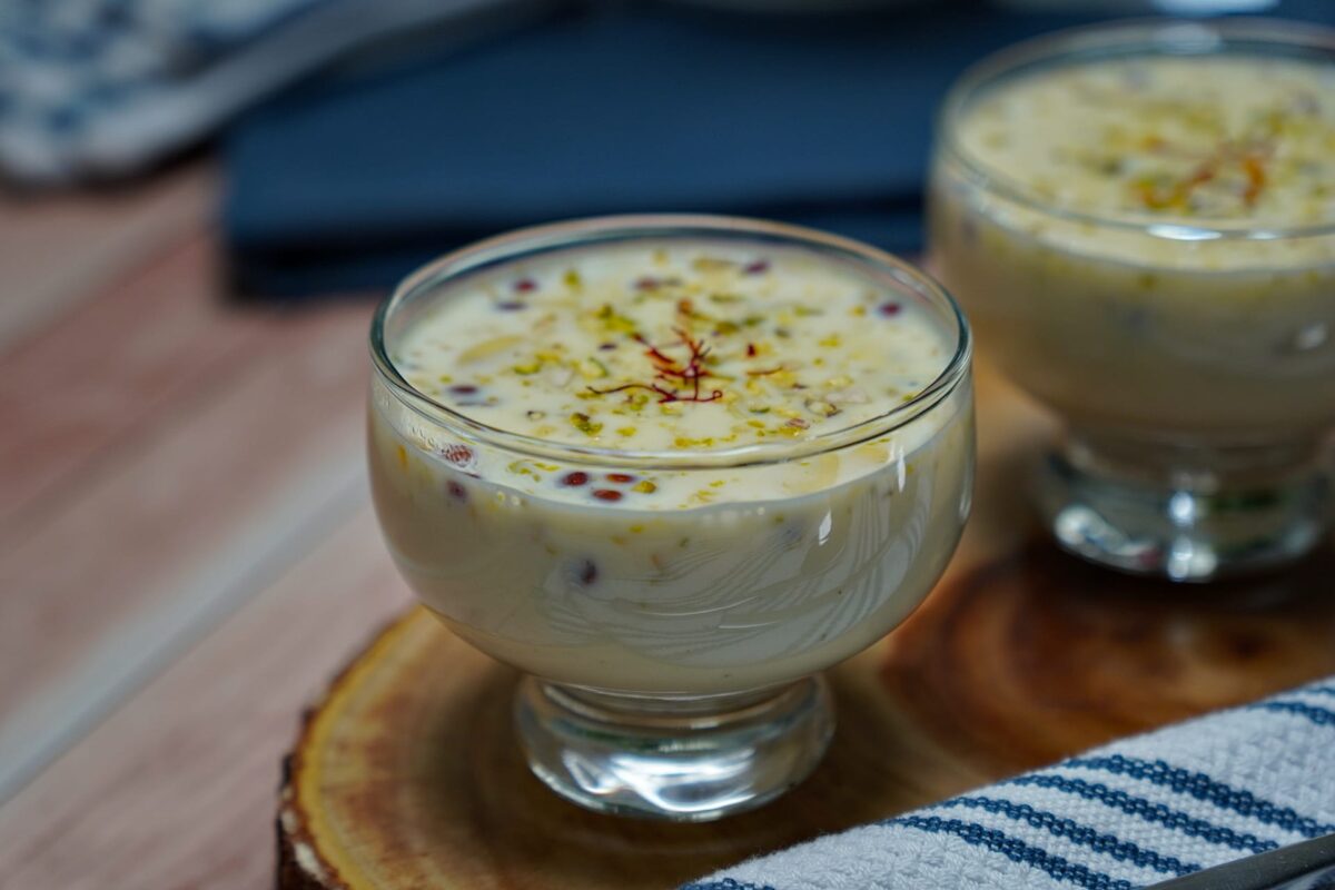 A bowl of Sabudana Kheer garnished with chopped nuts and saffron strands, showcasing its creamy texture.