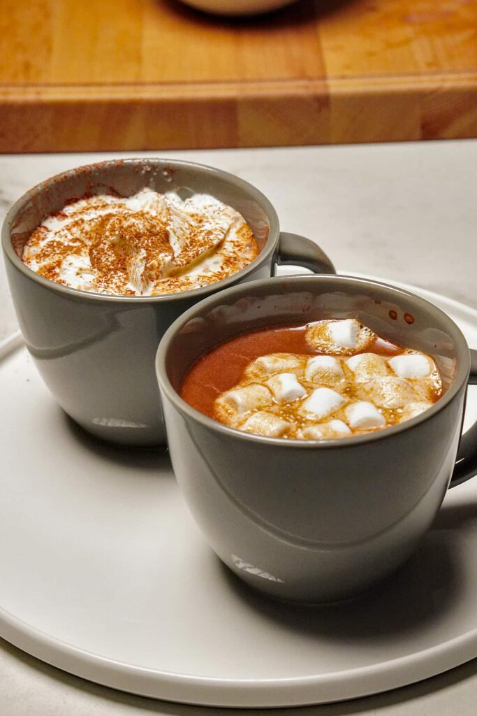 A top-down view of a mug of dark hot chocolate, highlighting the smooth surface and vibrant colors