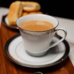 Freshly brewed hot masala chai with cardamom and ginger in royal cup