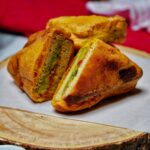 Crispy Bread Pakora served with a side of green chutney and tomato ketchup for dipping