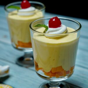 Close-up view of Heavenly Mango Mousse, highlighting the smooth and airy texture topped with whipped cream.