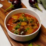 Delicious Ringan Batata Nu Shaak served in a traditional bowl, garnished with fresh coriander.