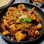 Delicious Chicken Chettinad served alongside freshly made roti, perfect for dipping into the rich gravy.
